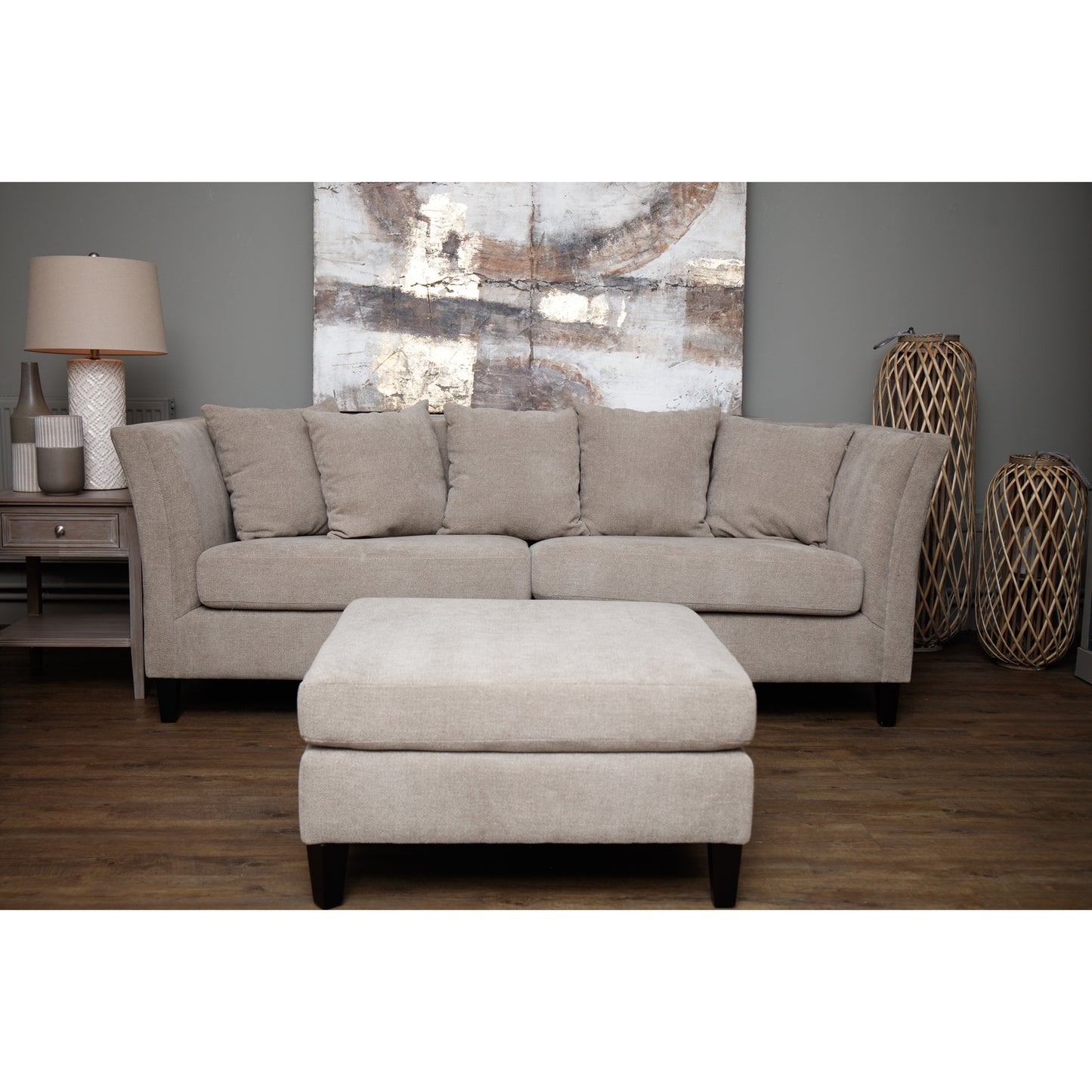 Three-seater taupe sofa with plush back cushions and neutral woven upholstery