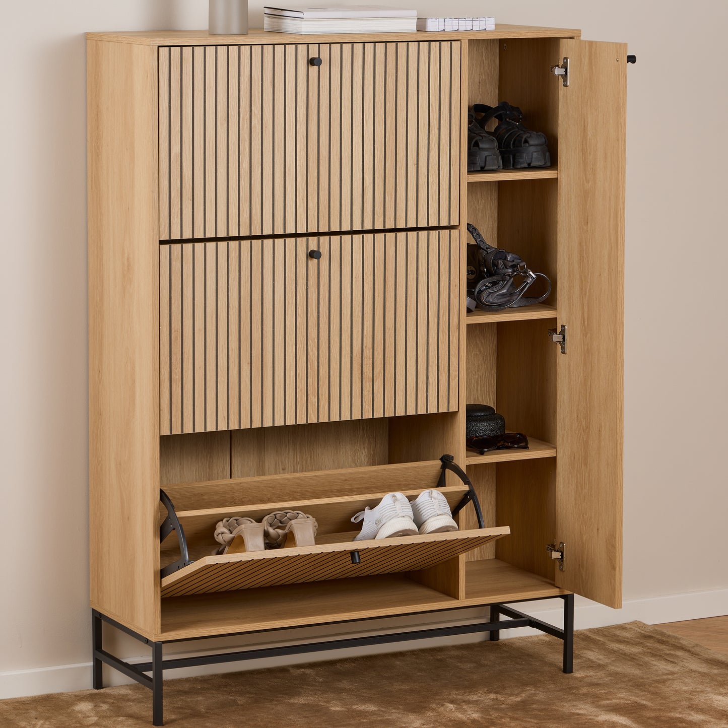 Modern oak shoe cabinet with black metal base, featuring 3 flip-down shoe compartments and a side cabinet with internal shelves, styled in a Scandinavian hallway.