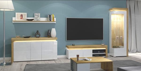 Modern living room with a television, sideboard, and decorative items.