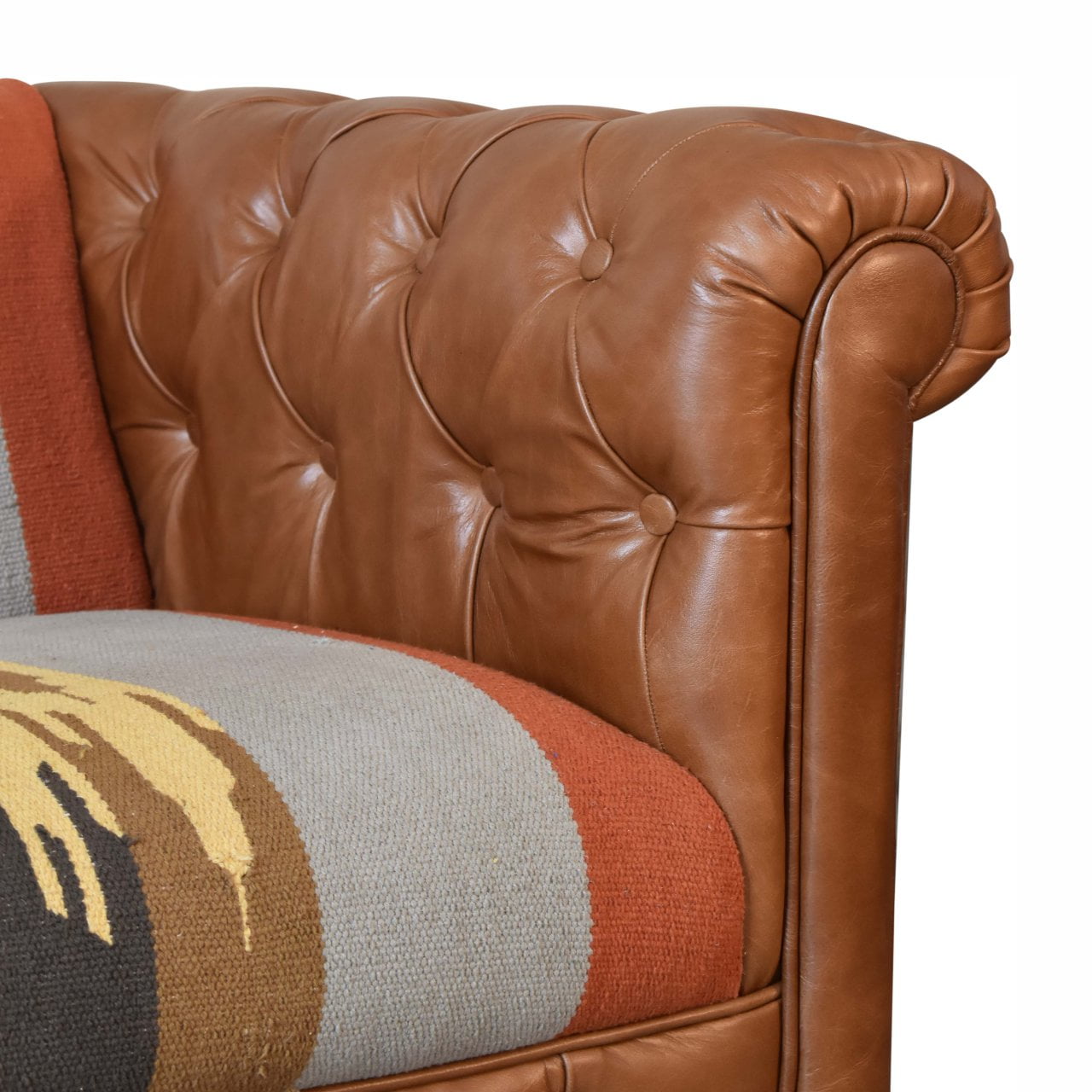 Handcrafted Kilim and Leather Chesterfield Sofa featuring a tufted tan leather frame, traditional rolled arms, and a bold multicolour kilim upholstery with geometric patterns, blending rustic charm and contemporary design.