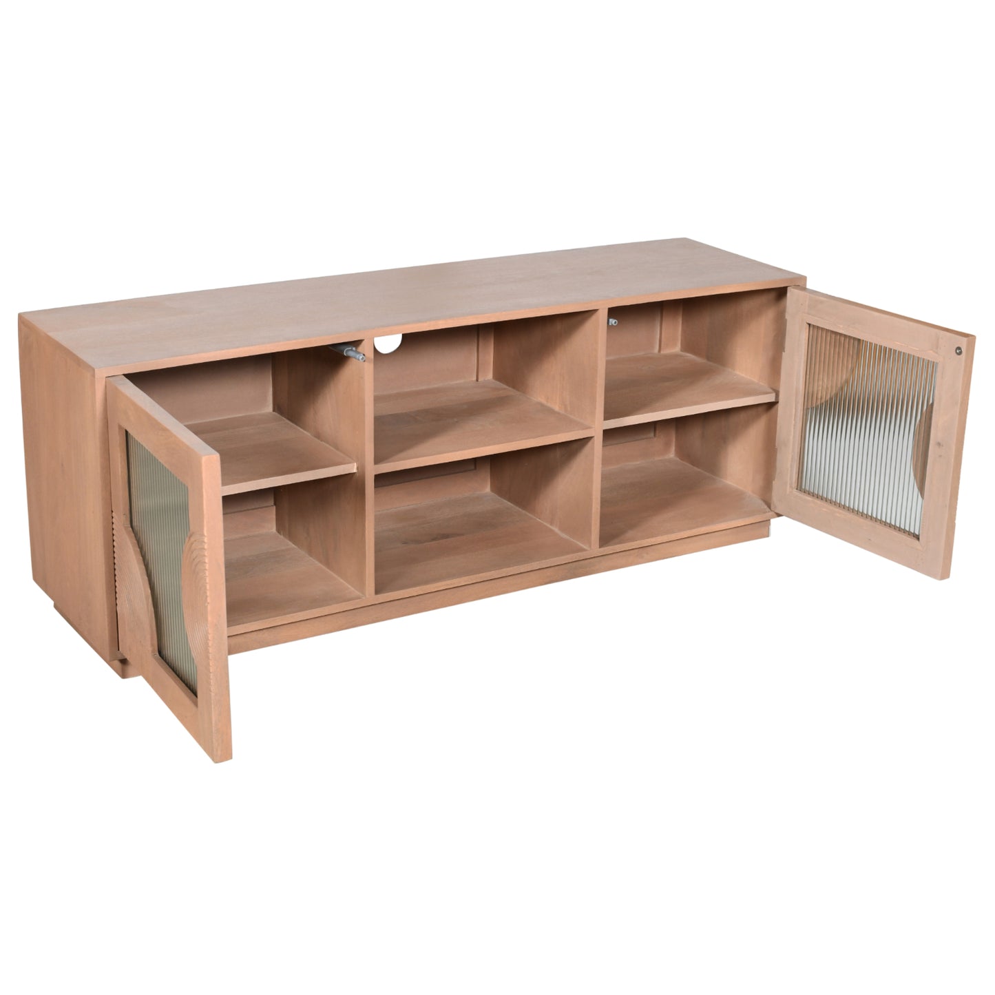 Indus solid mango wood TV cabinet with fluted glass doors, pale taupe lacquered finish, and open shelf storage for media devices, styled in a neutral-toned living room.