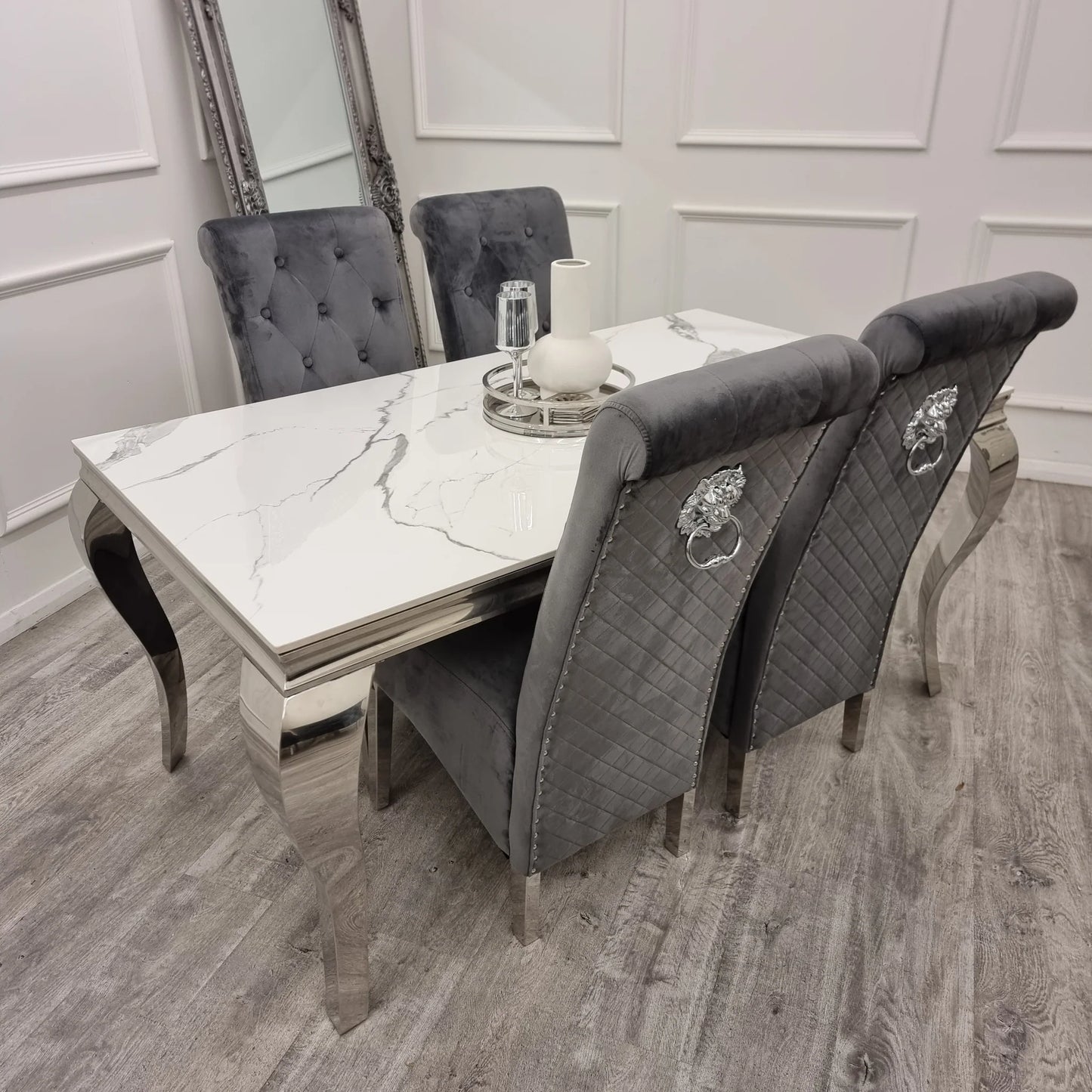 Emma dining chairs in cream velvet with tall scroll top, button stud detailing, quilted back and chrome lion knocker, paired with chrome legs