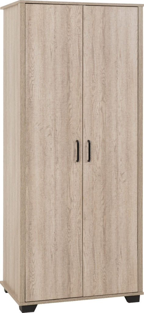 Oliver 3-piece bedroom set in light oak finish featuring a wardrobe, chest of drawers and bedside table, styled in a modern neutral-toned room with natural light