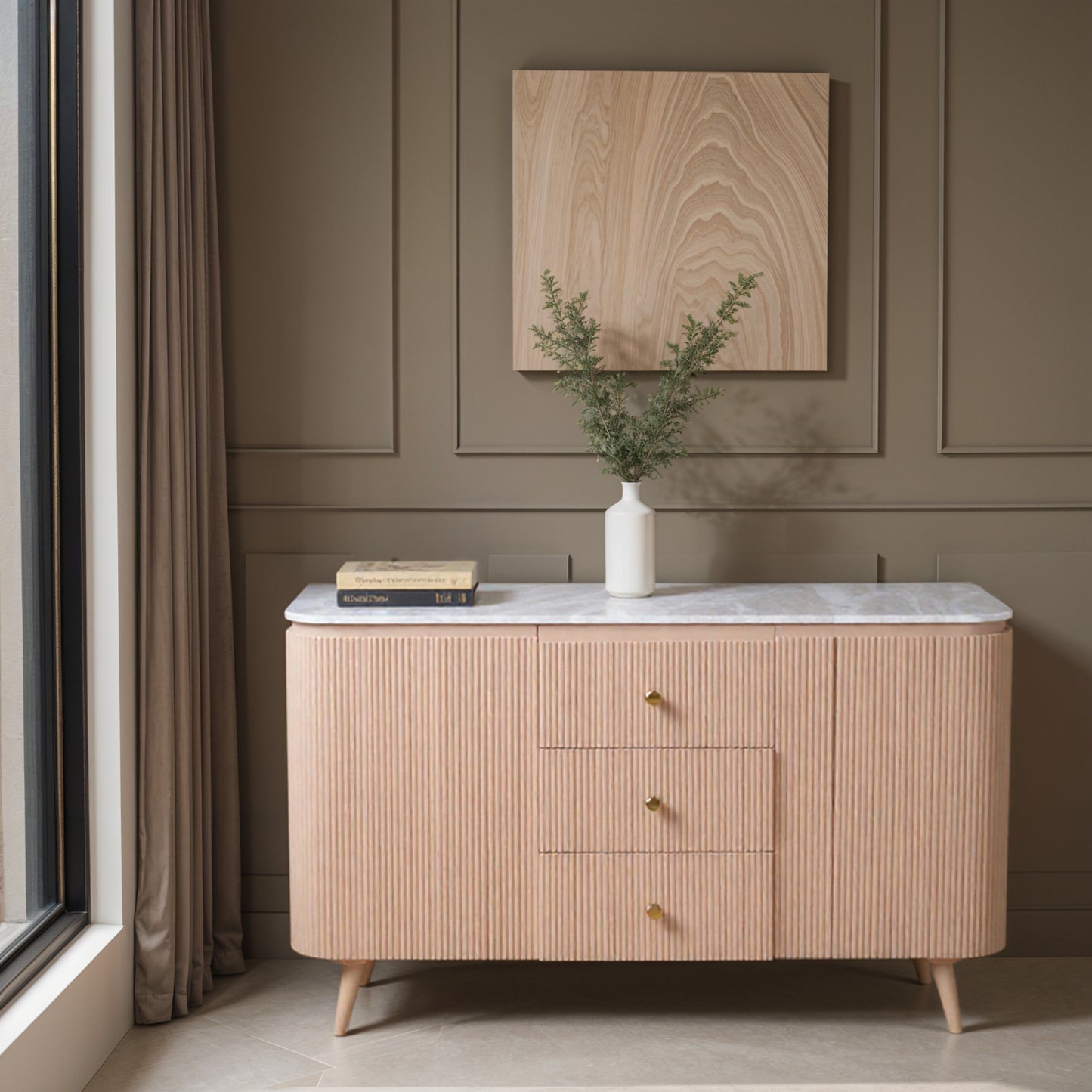 Luxury marble top sideboard in pale taupe mango wood with ribbed detailing and gold knobs, styled in a modern interior with neutral wall panelling and minimalist decor.