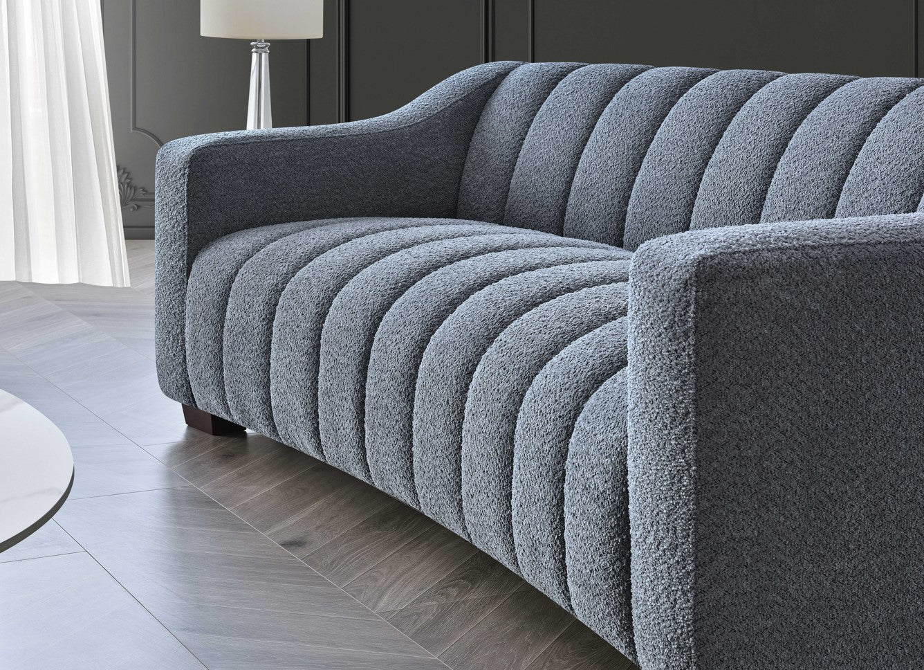 Aluxo Astoria 3 seater sofa in iron bouclé fabric with deep channel stitching and soft curved edges, styled in a modern, luxurious living room setting.
