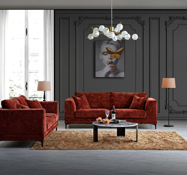 Aluxo Lenox sofa in rust velvet fabric, featuring a mid-century modern design with deep cushions, clean lines and a wooden plinth base on black legs