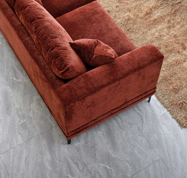 Aluxo Lenox sofa in rust velvet fabric, featuring a mid-century modern design with deep cushions, clean lines and a wooden plinth base on black legs