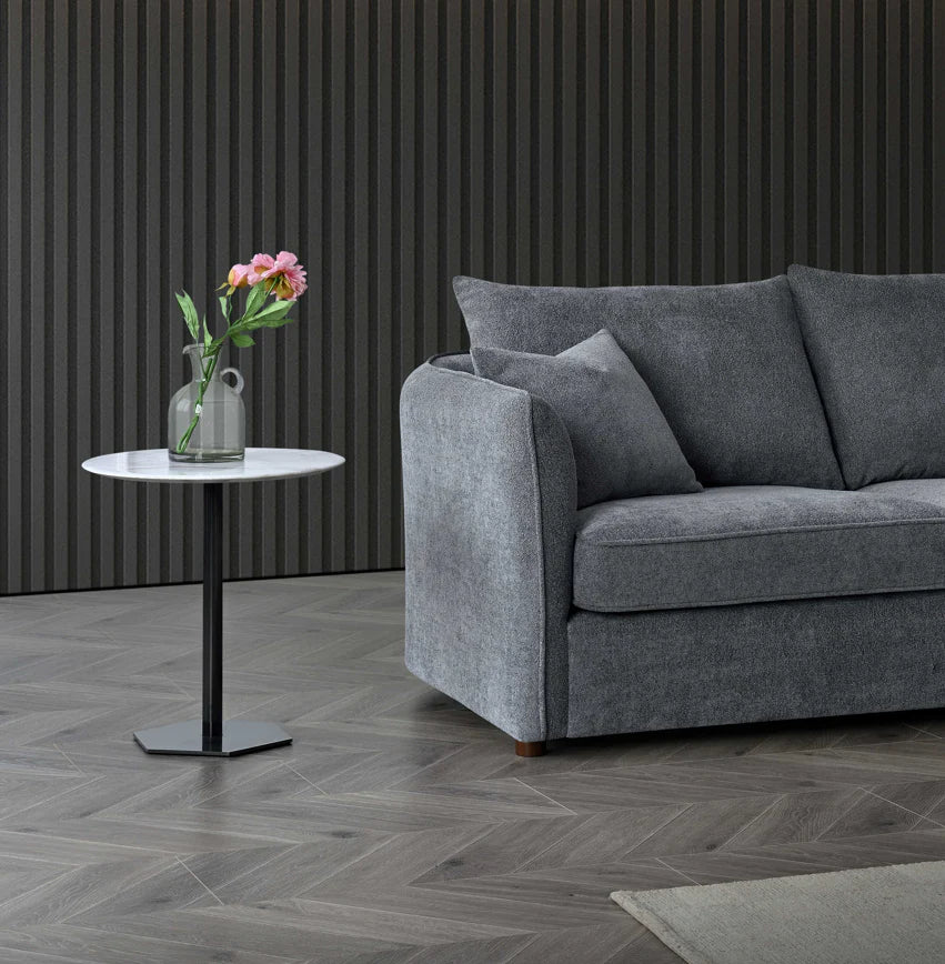 Rubin curved corner chaise sofa upholstered in charcoal bouclé fabric, featuring a sculptural design with deep cushions and a modern organic silhouette, styled in a luxury living room setting