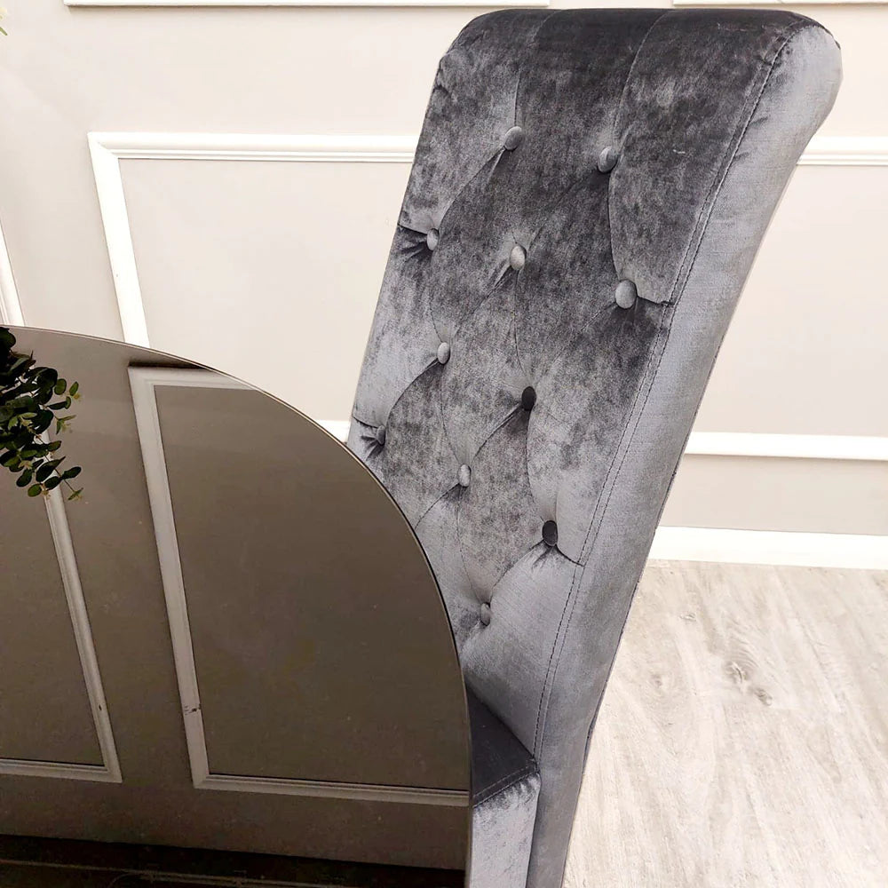 Emma dining chairs in cream velvet with tall scroll top, button stud detailing, quilted back and chrome lion knocker, paired with chrome legs