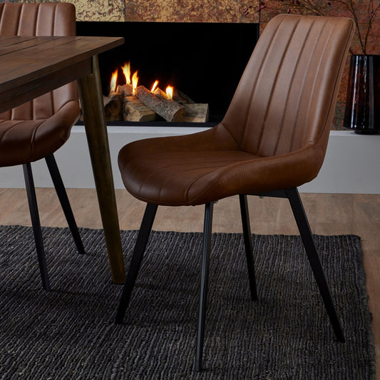 Modern tan faux leather dining chair with black metal legs in Nordic interior