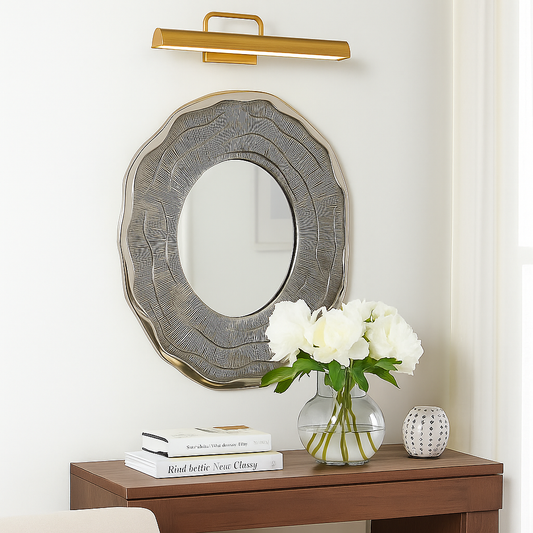 Decorative mirror with floral arrangement on a wooden console table