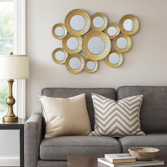 Decorative wall mirror with circular mirrors above a gray sofa with patterned cushions.