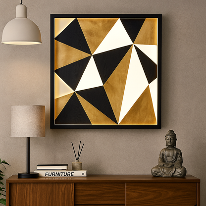 Geometric abstract art piece on a wall above a wooden console table with decor items.