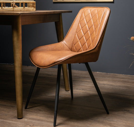 Tan faux leather dining chair with diamond-stitched backrest and black legs