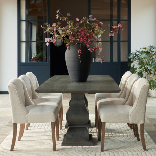 Cream boucle upholstered dining chair with wooden legs in contemporary room