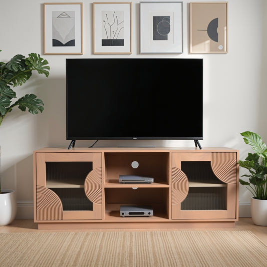 Indus solid mango wood TV cabinet with fluted glass doors, pale taupe lacquered finish, and open shelf storage for media devices, styled in a neutral-toned living room.