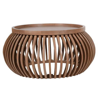 Indus small round coffee table in pale taupe mango wood with slatted design and built-in shelf, styled in a modern neutral-toned living room.