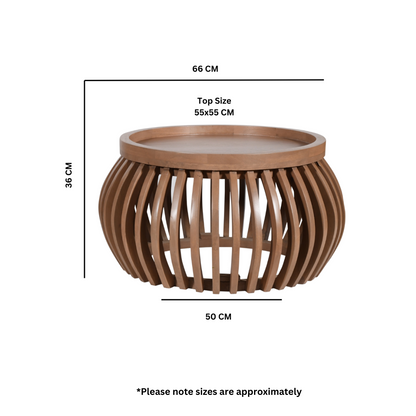 Indus small round coffee table in pale taupe mango wood with slatted design and built-in shelf, styled in a modern neutral-toned living room.