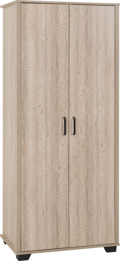 Oliver 3-piece bedroom set in light oak finish featuring a wardrobe, chest of drawers and bedside table, styled in a modern neutral-toned room with natural light