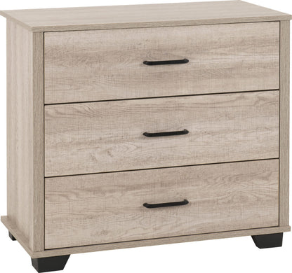 Oliver 3-piece bedroom set in light oak finish featuring a wardrobe, chest of drawers and bedside table, styled in a modern neutral-toned room with natural light