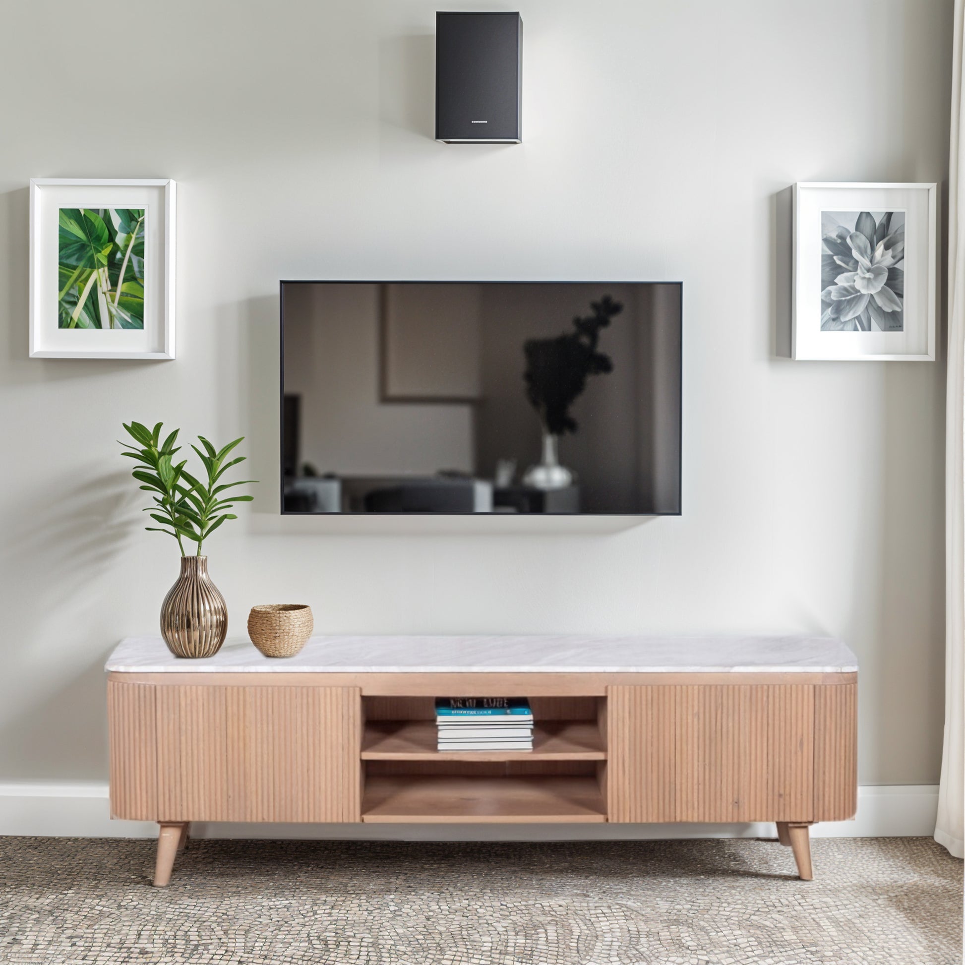 Ashford large TV cabinet with natural marble top and ribbed pale taupe mango wood body, featuring gold accents and modern storage layout in a minimalist living room.