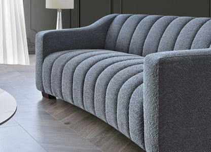 Aluxo Astoria 3 seater sofa in iron bouclé fabric with deep channel stitching and soft curved edges, styled in a modern, luxurious living room setting.