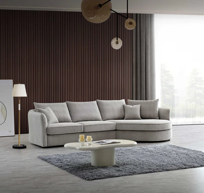 Aluxo Rubin Corner Chaise Sofa in Pebble Bouclé with sculptural curved shape, soft textured fabric, and modern design for luxury living rooms